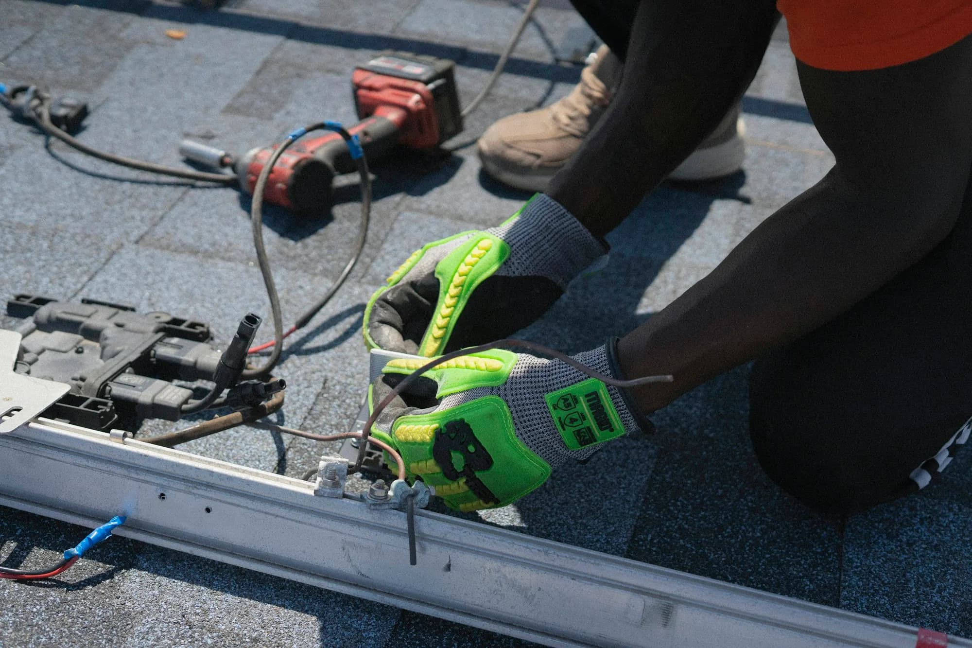 Technician wiring electrical components of a solar installation