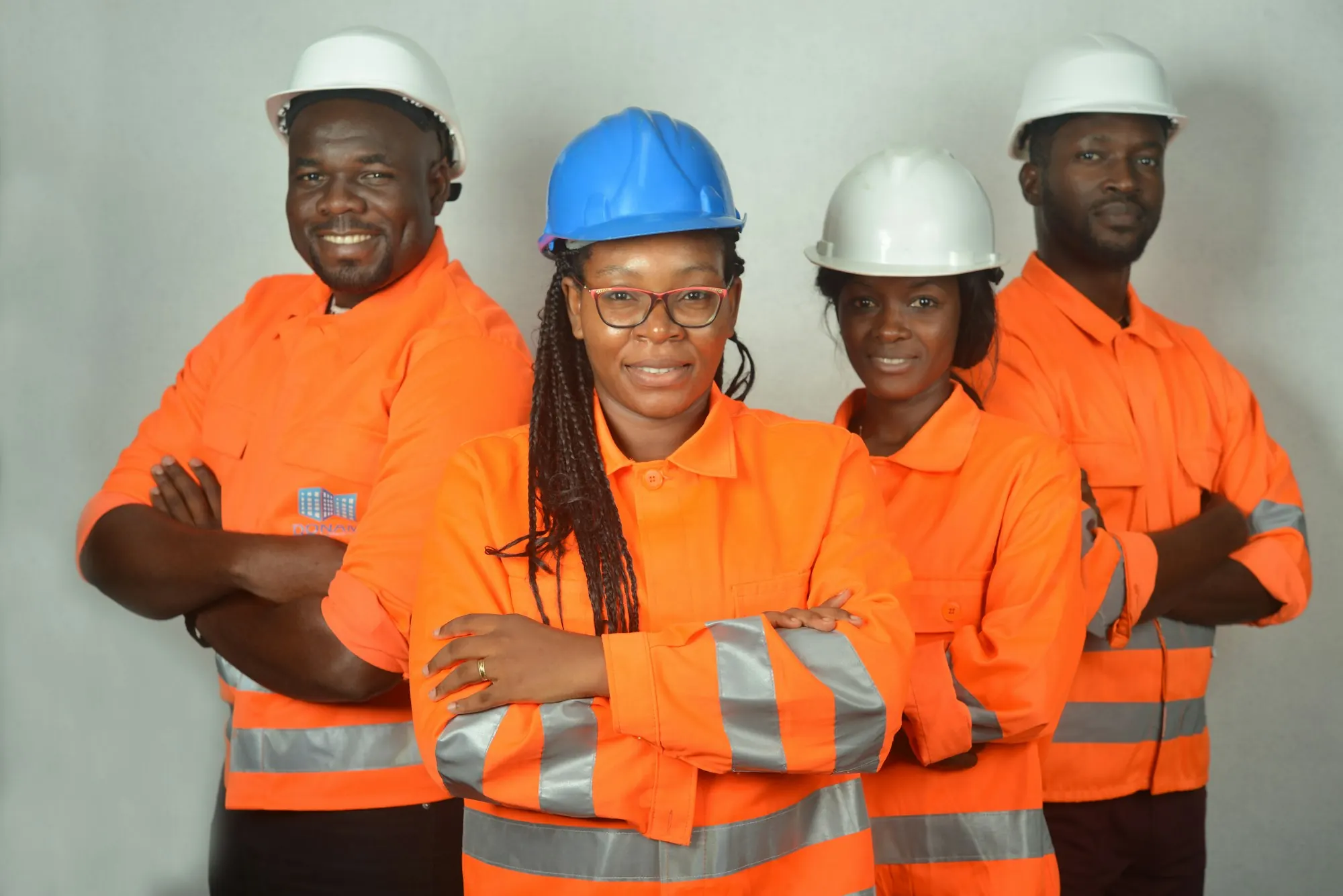 Team of women and men engineers in safety gear